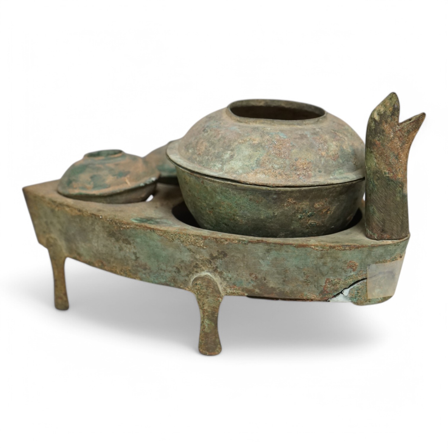 Four Chinese bronze zoomorphic stoves, Han Dynasty, 22cm, together with a Han Dynasty bronze brazier and vessels, width 22.5cm, (5). Condition - poor to fair.